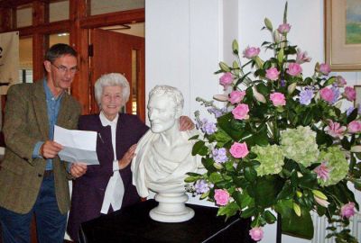 Tribute in verse
Former Commodore Clyde and Argyll and Bute Councillor Eric Thompson MBE, who read a poem he had composed for the occasion, with exhibition organiser Doris Gentles at the opening of the Henry Bell and the Comet exhibition in Helensburgh Library on Friday August 3 2012. The flower arrangement beside the bust of Henry Bell was by Judy Noble. Photo by Eleanor McKay.
