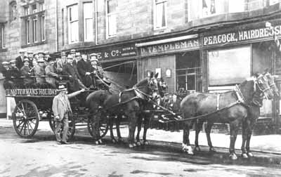 Motormen's Outing
Helensburgh motormen leaving for their annual trip from the Waldie & Co. motor and carriage hirers premises in Sinclair Street, circa 1917. Seeing off the party is John Hamilton of Waldies, and the carriage is being driven by Mr Reynolds, who often drove this carriage and was also the firm's undertaker.
