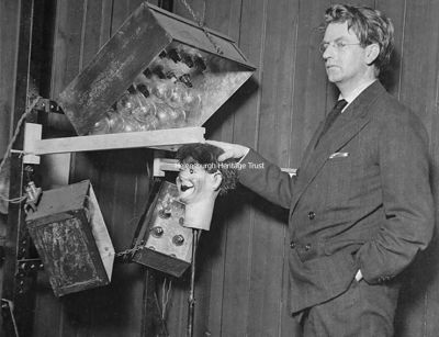 Stooky Bill
An October 3 1929 newspaper image of John Logie Baird with Stooky Bill, the dummy he used in his demonstrations, and TV equipment. The caption stated: "One more dream of science has been realised. Man's vision has spanned the Ocean, and transatlantic television has been demonstrated to be a reality. A man and a woman sat before an electric eye in a London laboratory last night, and a group of people in a darkened basement in the village of Hartsdale, New York, watched them turn their heads and move from side to side. The images were crude and broken, but they were images nevertheless."
