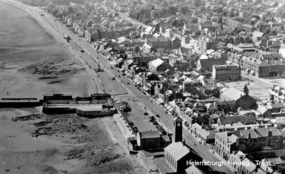 Aerial view to west
A view of the west side of Helensburgh town centre, including the Old Parish Church, the old Granary building at the foot of Sinclair Street, the outdoor swimming pool, and the Tower Cinema and Pender's Garage in Colquhoun Square â€” all now demolished. Image date unknown.
