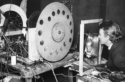 Checking equipment
A press picture dated October 3 1929 shows John Logie Baird with his transmitting equipment. The caption stated: "Mr Wm Baird of London is the inventor of wireless vision, a means by which objects can be wirelessed without the aid of photographs, on the same principle as sound is now transmitted by wireless. By his invention, one will be able to receive messages as at present with the addition that the listener will actually be able to see who is speaking for see actual events at the moment they are occurring."
