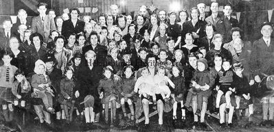 British Legion
Little is known of this picture of a British Legion function in the now demolished Drill Hall in East Princes Street, Helensburgh. A mother holds twins at the front, and there appears to be a Christmas tree at the back. The editor would welcome any more information â€” please use the Contact Us facility on the Trust website homepage. Image supplied by Rae Simon.
