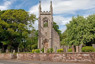 Cardross Old Parish Church
The church, the second on the site, was built in 1826 to designs by Greenock architect George Dempster. It was destroyed by incendiary bombs dropped by German bombers over the night of May 5-6 1941. The tower and walls were made safe in 1954 as a memorial, with the interior raised as a lawn, and the tower was restored in 1999. The graveyard contains monuments from the 17th, 18th and 19th centuries. This image taken from the main road was supplied by Donald Fullarton.
