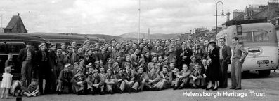 RAF squadron visit
A previously unpublished picture from a fighter pilot's scrapbook of members of the RAF's 610 Squadron on summer visit to Helensburgh from their base in Cheshire in 1938. They have donned tartan berets, much to the amusement of local children. The following year war broke out and two years later these men were fighting in the Battle of Britain and Helensburgh had its own RAF station. Image supplied by Robin Bird.
