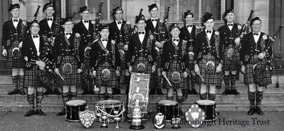 Clan Colquhoun Pipe Band
The Helensburgh-based Clan Colquhoun Pipe Band outside Clyde Street School in 1952. Back: Jimmy Simpson, Ian Laurie, Dougie Martin, Tommy Williams, Malcolm Gilmour, Mick Thrule, Jimmy Martin; front: Pipe Major Archie McNicol, John Cameron, Robert Toole, Andy Clark, Tom McDougall, Jim Gunn. Two members missing from the picture were A.McLean and John Boyle.
