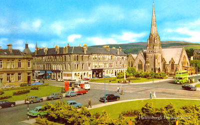 Colquhoun Square
A green Garelochhead Coach Services bus is at the bus stop on a sunny morning in Helensburgh's Colquhoun Square. Image circa 1970.
