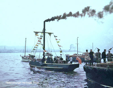 Comet replica 1962
The Comet replica, built by apprentices at William Lithgow at Port Glasgow for the 150th anniversary of the first sailing of Henry Bell's Comet, Europe's first commercial steamship, is seen setting off from Port Glasgow before steaming across the Clyde accompanied by a fleet of yachts. To mark the anniversary, the replica sailed from Port Glasgow to Helensburgh, with civic dignitaries on board in costume for 1812. Image taken and supplied by Jim Bamber.
