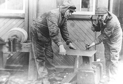 Hard at work
Two workmen at the North British Railway workshop at Craigendoran Station and Pier about 1910-1914. On the right is William Halford of Helensburgh.
