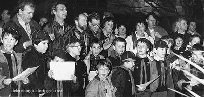 Singing in the rain
Members and leaders of the Helensburgh District Cubs are ready to sing outside on a wet night in 1991. Image supplied by Geoff Riddington.
