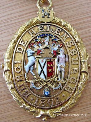 Provost's chain
The medallion which hangs at the foot of the Helensburgh Provost's chain of office. It states Burgh of Helensburgh 1802, the year the town became a Burgh of Barony. Photo by Stewart Noble.
