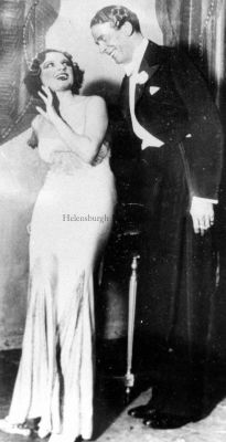 Jack Buchanan
Helensburgh-born Jack Buchanan (1891-1957), a major UK musical comedy, revue and film star, choreographer, director, producer and manager, was much associated with top hats and tails. The name of the actress in this picture is not known.
