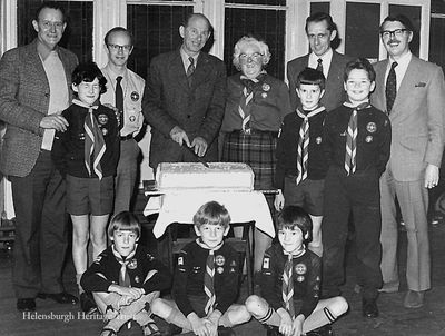 Cutting the cake
Helensburgh Cubs and Leaders at the cutting of the Jubilee cake in the Victoria Hall in 1982. Among those in the picture are Alan Crawford (left), David Reid (2nd from left), Mrs Mary Copeland (centre), John Gorrie (extreme right), his son Peter Gorrie is in front of him. Image supplied by Geoff Riddington.
