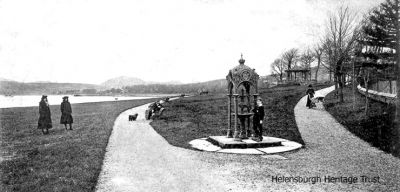 Ornate fountain
A young boy poses beside an ornate drinking fountain which used to stand in Helensburgh's Kidston park. Image c.1903.
