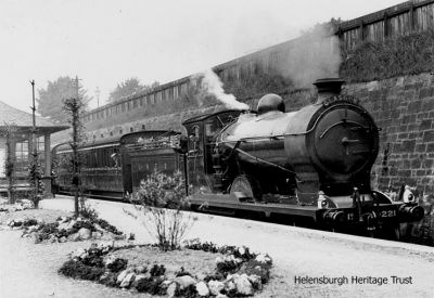 LNER train at Helensburgh Upper
A LNER passenger train on the West Highland Line waits at Helensburgh Upper Station before completing its journey to Glasgow. The engine's number is 221 and its name was Glen Orchy. It had a 4-4-0 arrangement. Image circa 1928.
