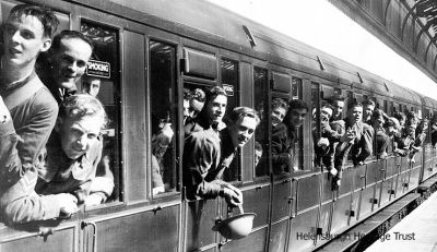 Heading for camp
Territorials of 162 Battery 54th Light Anti-Aircraft, Royal Artillery, from Helensburgh leave Helensburgh Central Station in September 1939 on route to England for training. They marched from the Drill Hall in Lomond Street to the station led by a piper. Among those in the picture are D.Kennedy, Gordon Hattle, Wug Robertson, G.Bailey, G.Nicholson, Tom Rennie, Angus McKell, Tom Rennie, Lachie McDonald, John Joseph Donnachie and Ian Lawrie. They were in France till June 21 1940, having served in Rheims protecting airfields and retreating to Marseilles where they embarked on a collier, possibly the last British ship to leave. They were taken to Gibralter. Image supplied by Lachie McDonald's daughter, Mrs Betty Stewart, who remembers seeing them march off to war.
