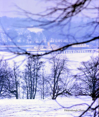 Frozen steamer
The Maid of the Loch steamer is ice-bound beside the pier at Balloch, Loch Lomond, in the big freeze of 1963. People can be seen standing on the ice at the end of the pier. Photo by Iain Duncan.
