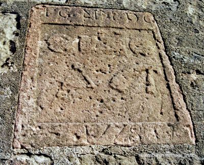 Maitland Street plaque
This worn carved stone in the wall at the foot of Maitland Street dates from 1778 and denotes the productive local trade of herring fishing in the early 19th century. The cured fish were stored in barrels made in the cooperage there. Photo by Kenneth Crawford.
