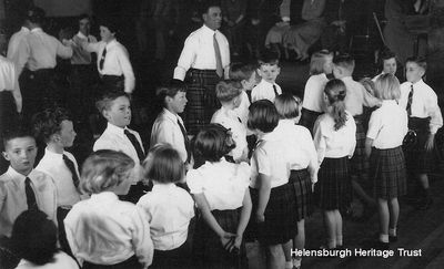 Rhu parents evening
Children prepare to dance at a parents evening in Rhu Village Hall for nursery gardener Alec Parlane's Country Dance Classes, circa 1955. Image supplied by Alistair Quinlan.
