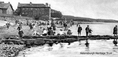 Relaxing on seafront
This old view from Helensburgh pier looking east shows townsfolk young and old on the beach making the most of a good day. Image date unknown.
