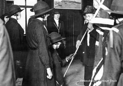 Royal Guide Colours
HRH Princess Louise, the Dowager Duchess of Argyll, who lived the later years of her life in Rosneath Castle, presents new colours to the 1st Rosneath Peninsula Girl Guides in 1928. On another occasion she presented the Union Flag to the 1st Cove and Kilcreggan Guides, and it is the oldest in the County of Dunbartonshire and still used in parades. She is also believed to have presented Campbell neckties to the Guides. Image by courtesy of Rosneath Castle Caravan Park.
