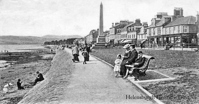 Family outing
A family take a seat on the West Bay promenade while another group play on the beach, circa 1907.
