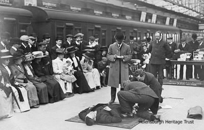 Wartime Red Cross demonstation
Members of the Helensburgh (North British Railway) Section of the Red Cross give a demonstration on a platform at Helensburgh Central Station during the First World War. Image circa 1916.
