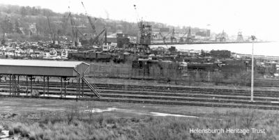 Faslane shipbreaking
The Shipbreaking Industries yard at Faslane, clearly illustrating that they broke up old railway locomotives as well as ships. After Faslane had been a military port in World War Two, at the end of 1945 the southern section was handed over to the Royal Navy who used it as a base for the Reserve Fleet. In August 1946 the rest was handed over to Metal Industries (later Shipbreaking Industries) for shipbreaking. Many famous vessels ended their days there, including the last four-funnelled liner, the Aquitania, the German battleship Derflinger which had been scuttled at Scapa Flow, and the last battleship built for the Royal Navy, HMS Vanguard. Image, date unknown, by courtesy of Stewart Noble.
