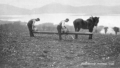 Sowing corn
Two farm workers prepare to sow corn on the hillside above Loch Lomond. Image circa 1906.
