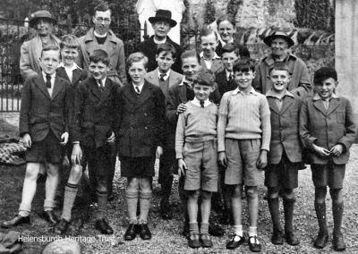 Choir trip
The choir boys of Helensburgh's St Michael and All Angels Church on a trip to Kilcreggan in 1941. Back row: Mrs Baird, ?, the Rev Charles B.Baird, ?, Robert Neil; middle: Robert Livingstone, Robert Hailstones, Tom Paterson, Roy Mackenzie, Robert Wright, Thomas Neil (Robert's brother), Robert Weir Lees; front: ?, ?, ?, ?, ?. The photograph, taken by church organist James P.Whimster, was kindly supplied by Robert Hailstones.
