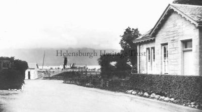 Steamer at Luss
The road down to Luss Pier, where a steamer is waiting, on a grey day. Circa 1915.
