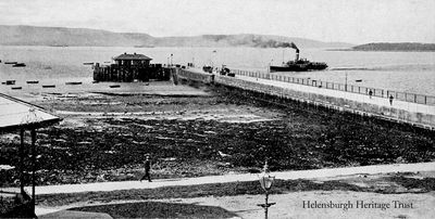 Steamer approaches
A steamer approaches Helensburgh pier, image circa 1928. The following year the outdoor swimming pool was built beside the pier. The image also shows the waiting room and ticket office building on the end of the pier, and on the left, part of the bandstand beside West Clyde Street.
