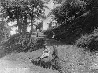 Strone Cottage
An 1894 photograph of Strone Cottage at Glen Mallan on Loch Longside, taken by a Professor Steggall, who had a house in Garelochhead. He was a keen walker and photographer, and took a number of pictures in the Glen Mallan and Glen Douglas areas. The cottage was demolished about 1961 when the military jetty was built there. Image supplied by Alastair McIntyre.
