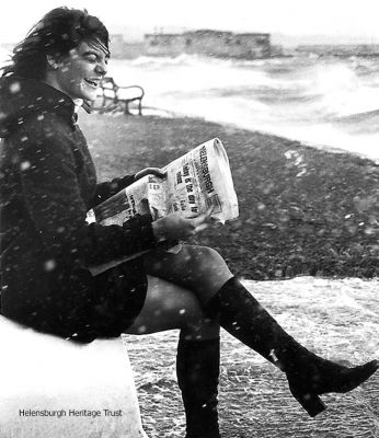 Publicity stint
The headline was "Some people will do anything for a good read of the Helensburgh Advertiser". Staff member Susan Cowan (now Mrs Maxwell) posed with the paper during a seafront gale on December 5 1972. Photo by Donald Fullarton.
