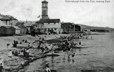 Pier View
Looking east from Helensburgh pier, with paddling where the pier car park is now. A funfair on the left and the old Granary can be seen in front of the clock tower. Undated.
