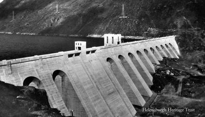 Loch Sloy Dam
The Loch Sloy Dam, near Tarbet. The UK's largest conventional hydroelectric power station, Sloy Power Station, takes water from Loch Sloy through four large pipes down the hillside giving a working height of 277 metres. Loch Sloy is fed by tunnels and aqueducts from a much larger area. The power station was opened in 1950 by the Queen Mother and was designed to provide power to Central Scotland at Scotland at times of peak demand. The station was refurbished in the late 1990s. Image date unknown.
